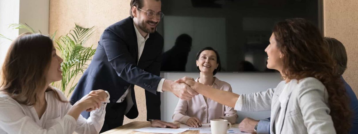 Happy business partners reached agreement shake hands after making profitable commercial deal. Formal meeting, sell services, congratulate promoted employee, express appreciation for great cooperation